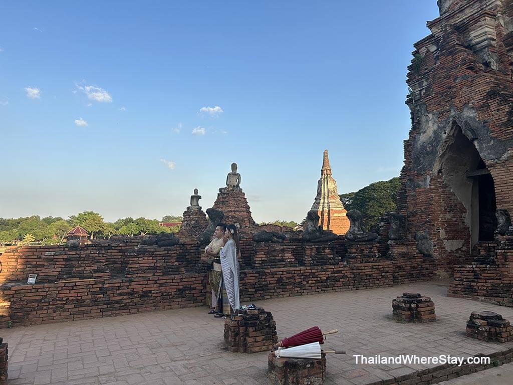 people wearing traditional clothes to take photos